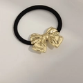 Minimalist black elastic hair tie featuring a polished gold metal bow decorative element - Pleated Bow Gold