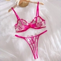 Close-up of fuchsia lace lingerie set with white floral embroidery and satin straps - Rose Red