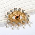 Brosche Goldenes böses Auge mit braunem Stein, Strasssteinen und weißen Perlen - Gelbes Auge-Radialer Strass