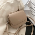 Minimalist apricot flap saddle bag with silver lettering and a slim shoulder strap - Khaki