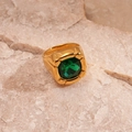 Macro shot of gold stainless steel ring featuring a large square green gemstone inlay - Green