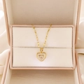 Detail of golden heart pendant with center crystal in a pink velvet jewelry box - Gold Multi-layer Heart (A-1064)