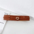 Detail view of a vintage brown wide belt featuring double layered PU leather and a square buckle - Camel