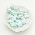 Pile of iridescent light blue bear-shaped beads in a white ceramic dish for DIY jewelry - Sky Blue