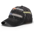 Detail of distressed baseball cap featuring colorful patches and vintage ripped textures - Washed Black (A)