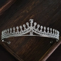 Elegant silver bridal tiara crown with clear sparkling rhinestones on a wooden tray - 28# Silver Rhinestone Curved Style