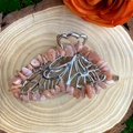 Detailed view of silver butterfly hair clip with pink natural crystal stones on wood - Sunstone Silver Butterfly