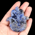 Blue natural crystal Hand of Fatima stone carving held in hand with evil eye detail - Blue Sodalite