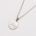 Macro detail of silver stainless steel round pendant with Joy engraving and fine chain - Silver (Joy Engraved)
