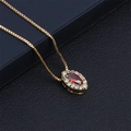 Macro shot of gold necklace with red marquise gemstone and cubic zirconia halo pendant - Red