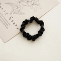 Detail of a black satin scrunchie with soft folds on a minimal aesthetic background - 6cm Satin Black