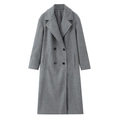 Detail of grey double-breasted coat featuring classic lapels and four black round buttons - Gray