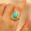 Vintage gold twisted rope ring with a large oval turquoise stone on model hand - Twisted Rope Braided Oval Style (2476) / Gold / Turquoise