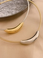 Macro shot of minimalist metal collars featuring bicolor crescent pendants on silk - Silver Choker + Gold Pendant