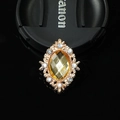 Macro detail of oval yellow crystal alloy charm with sparkling white rhinestones - Smoky Yellow