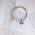 Gouden bedelarmband met dromenvanger, boze oog en fonkelende kristallen bedeltjes - Wit