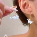 Elegant gold flower earrings with translucent petals and hanging pearls on model's ear - Three-petal Resin Artificial Pearl Hook Style (A-286) / Faux Pearl