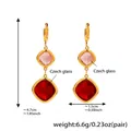 Detailed view of gold stainless steel earrings with pink and red Czech glass pendants - Gold Red Glass