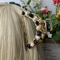 Golden hair claw clip with black and white stone beads on blonde hair styling - Obsidian + Deep Sea Pearl Gold Hair Claw