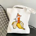 White canvas tote bag featuring a cute cartoon Corgi sitting inside a yellow banana peel - C12-Banana Corgi