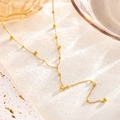 Bracciale minimalista in acciaio al titanio dorato con sfere lucide su catena sottile - Collana con Nappa / Oro