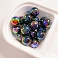 Macro shot of colorful UV plated round acrylic beads for DIY jewelry making - Black