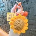 Handmade crochet sunflower keychain featuring an orange bell and exam success tag - Crochet Sunflower / Orange