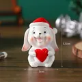 Miniature resin Christmas bunny figurine wearing a red Santa hat and holding a red heart - Rabbit - Boxed