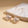 Close-up of heart-shaped champagne pearl earrings on a white marble background - Ear Hook-White