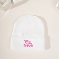 White knitted beanie with pink You are Good embroidery on a minimalist beige surface - White