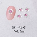 Detailed macro view of 7x7.5mm flower nail charms with pink crystals and silver base - Silver Camellia Pink Stone (A497)