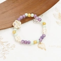 Handmade ceramic bracelet with purple yellow beads and floral accents on wooden base - 1005-01 Chunzhichu