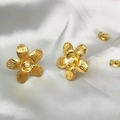 Detail view of gold flower earrings with pearls on soft white silk background - Gold Delicate Small Flower Style (TE-15119)