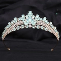 Detailed macro view of golden bridal tiara with opal-like blue stones and sparkling rhinestones - H1409 KC Gold + Green Opal