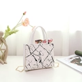 Detailed view of a white marble texture handbag with colorful silk scarf and gold chain strap - White