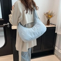 Quilted light blue puffy crescent shoulder bag with soft padding and wide strap - Blue