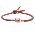 Close-up of pink adjustable cord bracelet with rhinestone evil eye charm and gold sliders - Pink Eye