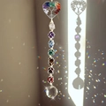 Detail of a 7 chakra Tree of Life crystal suncatcher casting rainbow light on the wall - Heart Tree of Life