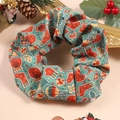 Close-up of green Christmas scrunchie with festive patterns of socks and trees - Christmas Style 2 (Green Christmas Tree)