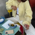 Minimalist light yellow button knit cardigan for women styled in a cafe setting - S / Yellow