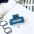 Translucent dark blue square hair claw clip made of acrylic on decorative background - Haze Blue