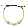 Detail of adjustable evil eye beaded bracelet with gold beads and blue enamel charms - Light Blue