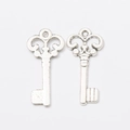 Pair of vintage silver alloy key charms with an antique finish on white background - Antique Silver