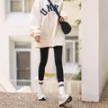 Glossy black thermal leggings with fleece lining paired with a white casual sweatshirt - 200g Full-foot [Plus Size] / Black