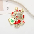 Detailed view of cartoon dragon brooch with red enamel and inlaid white rhinestones - Dragon Joy - Matte Gold