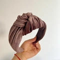 Detail of a brown pleated velvet headband with a knotted center for a stylish winter look - Brown