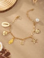 Gold ocean themed bracelet featuring shell, starfish, fish and pearl charms on sand background - Letter U(U)