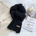 Classic black ribbed knit scarf featuring a premium brown leather logo patch - Black [Chunky Knit]
