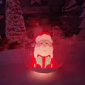 Transparent LED Christmas ball with Santa Claus design glowing in a snowy garden setting - Transparent Santa with Light