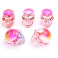 Pink and orange gradient crystal skull ornaments with iridescent finish on white background - No.22 (Pink Orange Gradient Phantom)